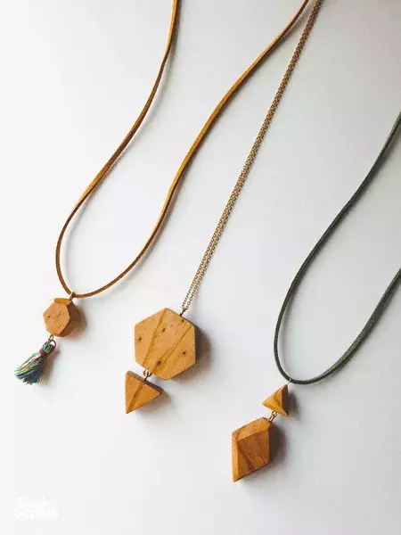 Wooden pendant necklaces with tassels on a white display at a Singapore woodworking jewellery workshop — workshops in Singapore