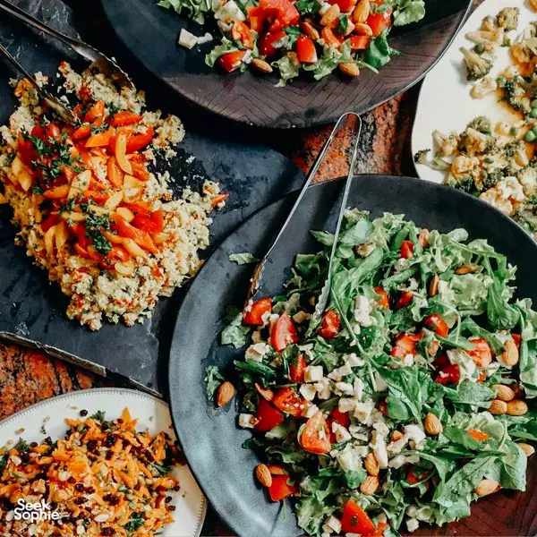 Gut-health meal bowls with leafy greens, herbs and chopped vegetables on ceramic plates at Phuket Cleanse retreat in Phuket