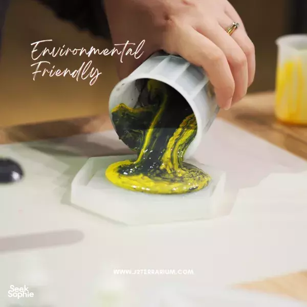 Yellow and green resin poured into a hexagonal coaster mould on a workbench at marble & terrazzo coaster making workshops in Singapore
