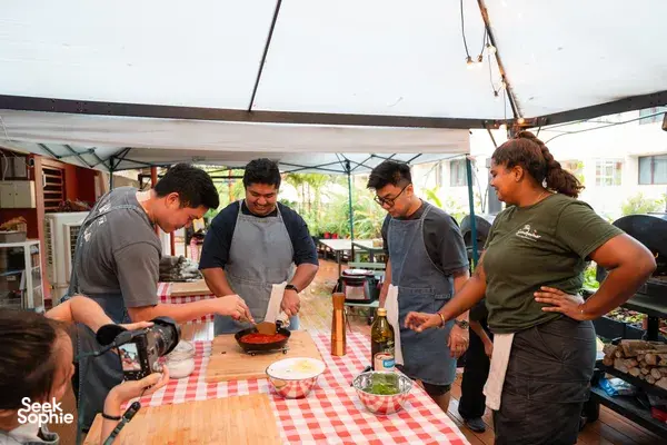 Wood-fired pizza-making at Secret Pizza Club in Singapore, kneading dough on a table under a canopy — workshops in Singapore