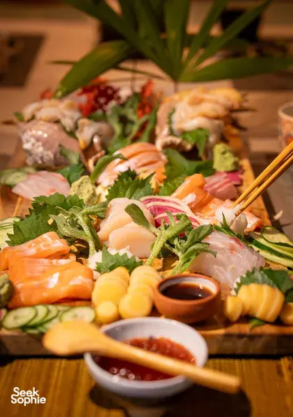 Primateve grazing platter spread of sashimi, vegetables and dipping sauces with chopsticks at a private dining Singapore experience