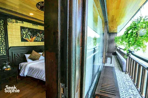Stateroom corridor with sliding doors and a small balcony ledge, Cat Ba Ocean Cruises suite overlooking Lan Ha Bay