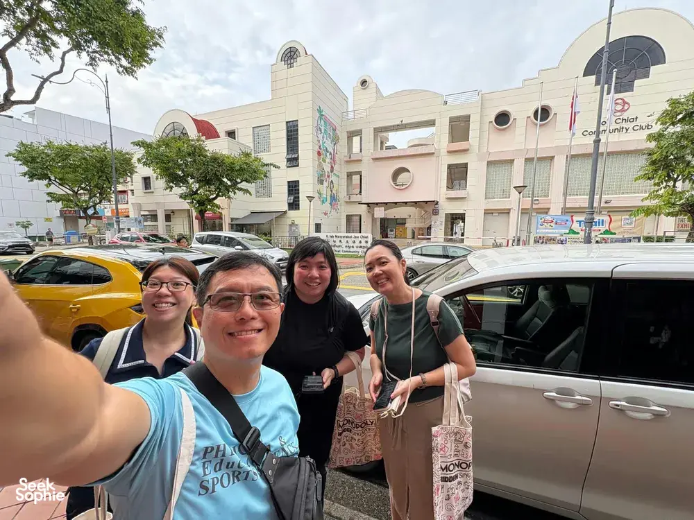 Group taking a selfie on the streets of Katong-Joo Chiat during a real-life Monopoly team game in Singapore, team building Singapore