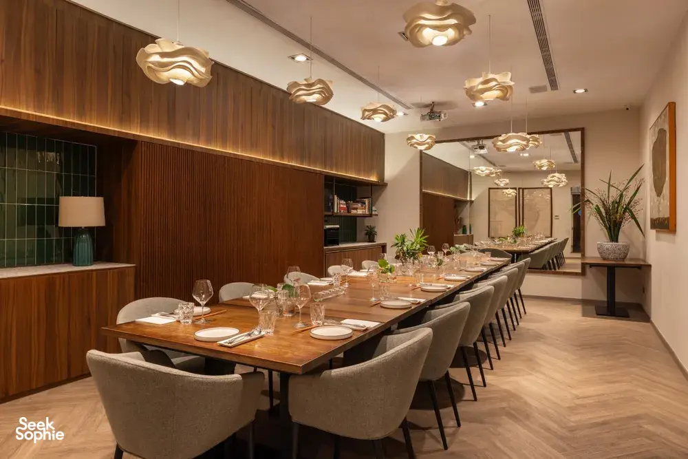 Wood-panel dining room with laid tables for served meals after a Singapore cooking session, private dining Singapore