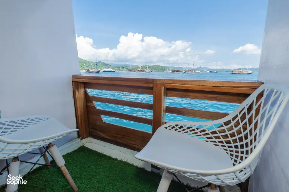 Balcony seats overlooking Labuan Bajo harbour from a Komodo boat trip cabin on a 3D2N join-in cruise