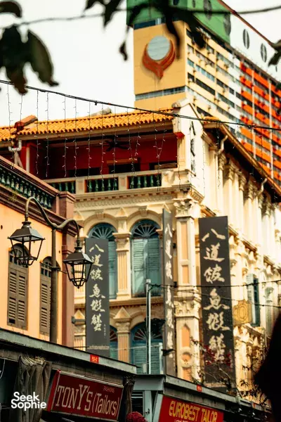 Heritage shophouses and street signs along a quiet lane in Singapore, with balconies and lanterns above as Singapore hidden gems