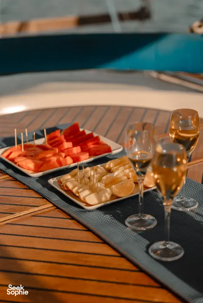 Seafood and watermelon appetisers with champagne glasses served on the wooden deck of a catamaran cruise off Kota Kinabalu