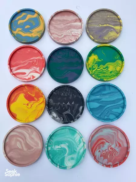 Assorted marbled Jesmonite coasters—red, blue, green, black and pastel—arranged in a neat grid for make-your-own workshops in Singapore