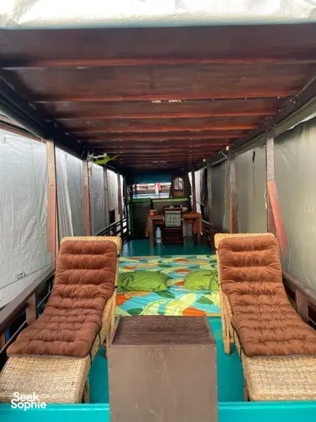 Cozy cabin on a small boat for a 3D2N Tanjung Puting cruise in Pangkalan Bun, with two lounge seats inside