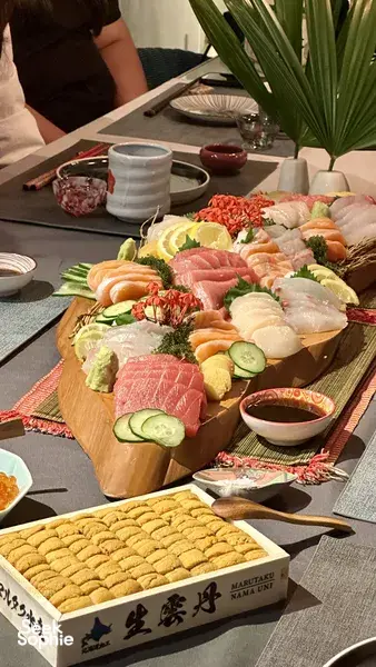 Assorted sliced seafood, cured meats and vegetables arranged on a wooden grazing platter at Primateve's table, private dining Singapore