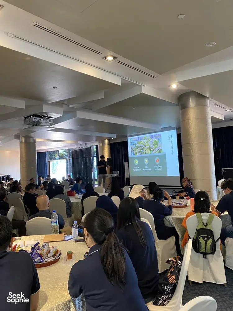 Workshop audience seated in a lecture room as Urban Green Dot presents sustainable microgreens for workshops in Singapore