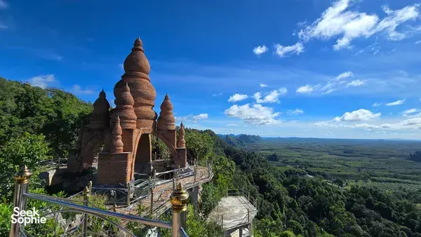 Buddhist stupa lookout over sweeping valley and green forest from Khao Sok National Park, with terrace railings