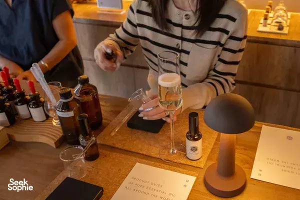 Held tasting glass and pipettes as a participant mixes essential oils to personalise a natural pillow mist in Singapore workshops in Singapore