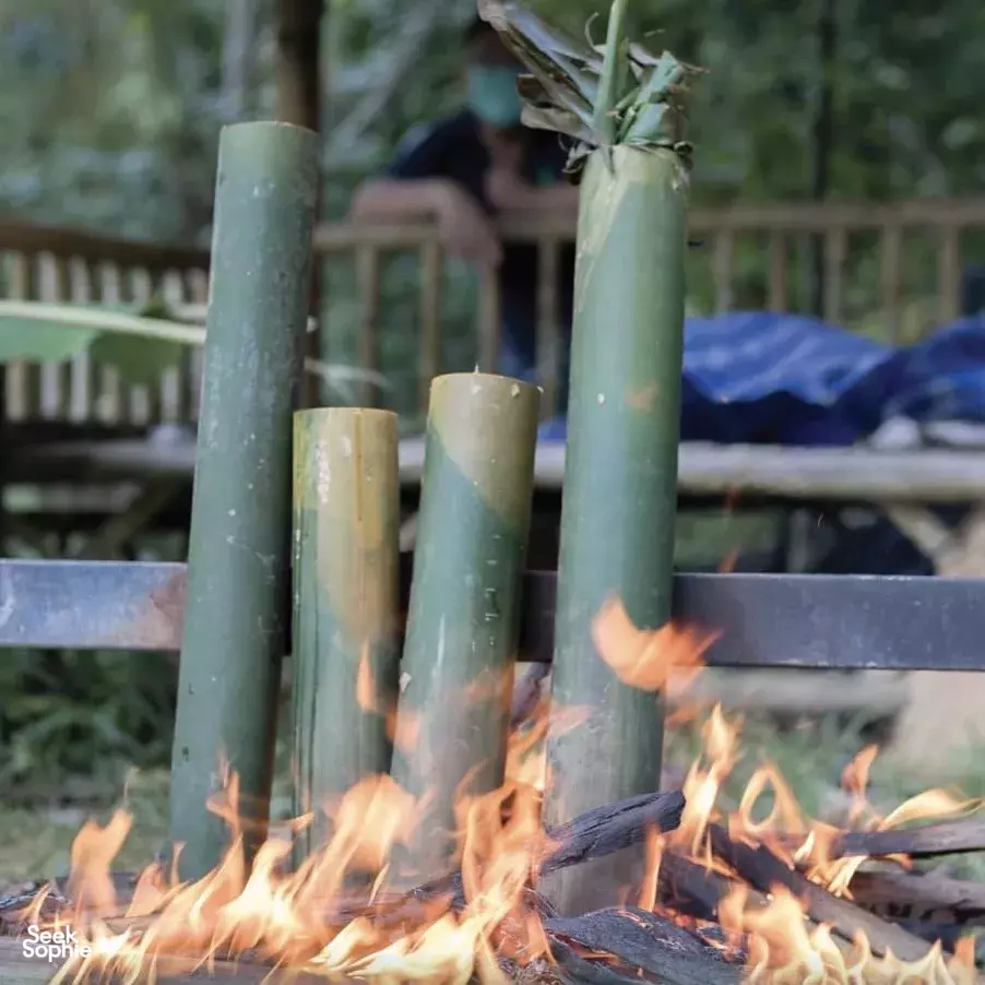 Flames from a bamboo fire pit at Anurak Lodge, creating a cosy campfire moment in the rainforest of Khao Sok National Park