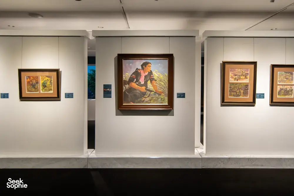 Framed paintings line white walls of Quang San Art Museum in Ho Chi Minh City, arranged for a guided Vietnamese art tour