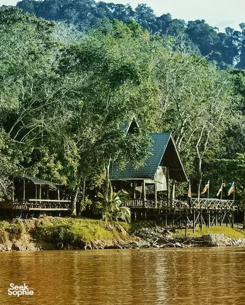 Wooden stilt cabin and river deck at Scenic Riverside Resort overlooking the Kinabatangan River in Sandakan, Borneo