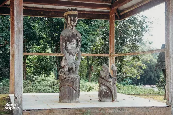 Carved wooden Dayak statues inside a village shelter at the edge of the rainforest in Pangkalan Bun, Tanjung Puting