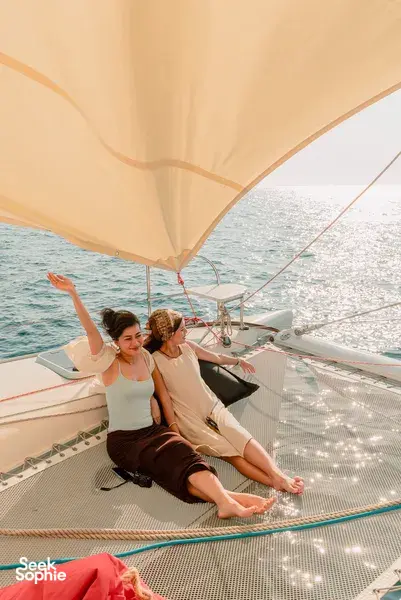 Sunbathing on the trampoline deck under a sail on SY Mawali catamaran near Kota Kinabalu