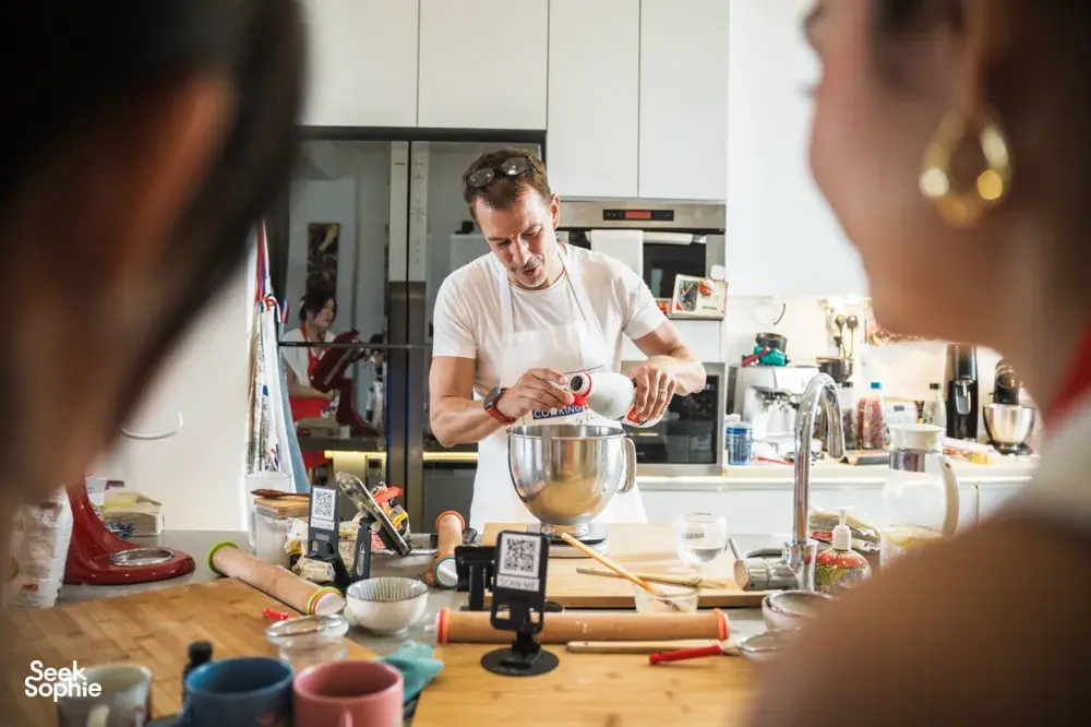 French Cooking Lab chef pouring ingredients into a stand mixer on the counter in Singapore for workshops in Singapore