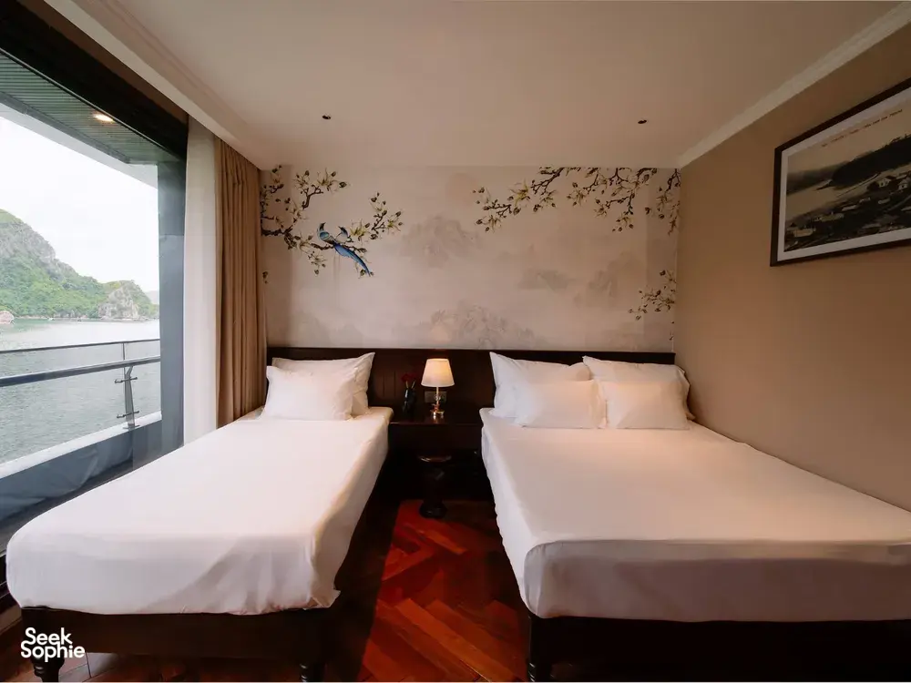Sunshine Golden Cruises Cat Ba cruise cabin with two twin beds and a large window overlooking the bay on a 2D1N stay