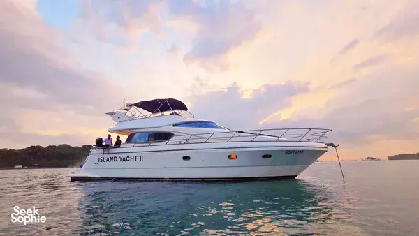 Motor yacht at golden hour on Singapore waters, Island Yacht captains hosting a Southern Islands 4-hour cruise