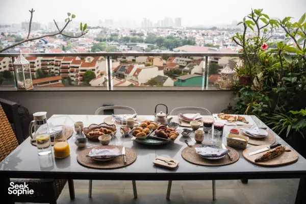 Croissant-tasting table on a rooftop terrace in Singapore with trays of pastries and teacups for workshops in Singapore