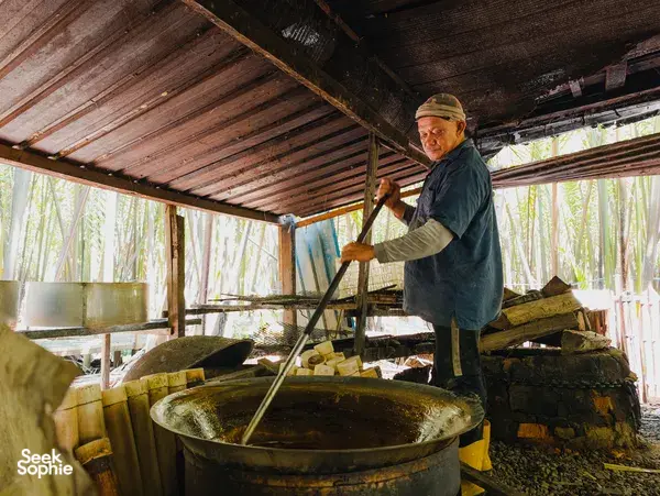 Hosted by Tanoti Crafts, palm sugar is stirred at a large cauldron in a rustic Sarawak workshop in Kuching