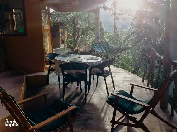 Terrace dining set with hammocks and chairs overlooking the Sinharaja rainforest at Natural Mystic Sanctuary eco-lodge