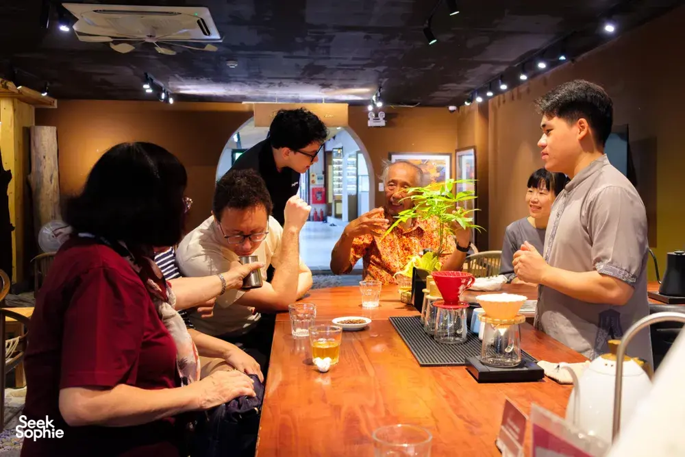 Guests learning about rare agarwood scent at a host-led tasting table in Hanoi, Vietnam, during an Up Travel Vietnam tour