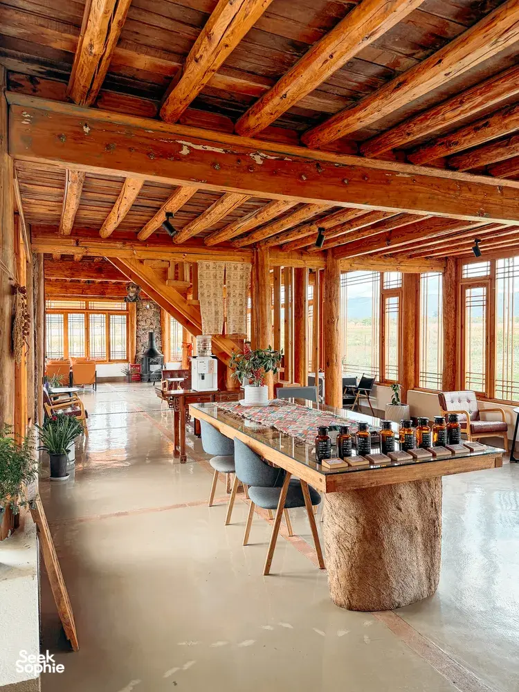 Wooden coffee tasting hall at Seeker Yunnan Coffee Estate in Lijiang, long counter set up with bottles and coffee-brewing gear