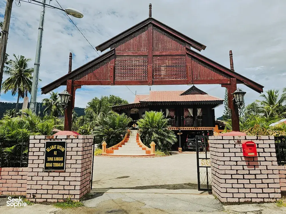 Red-roofed building entrance and gate in Langkawi, a landmark start along the villages, markets and jetty cycling route