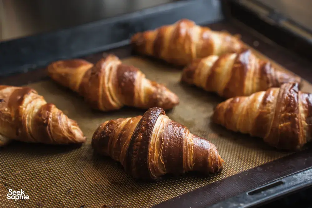 Golden croissants lined on a mesh tray during a bake-croissants class at French Cooking Lab in Singapore