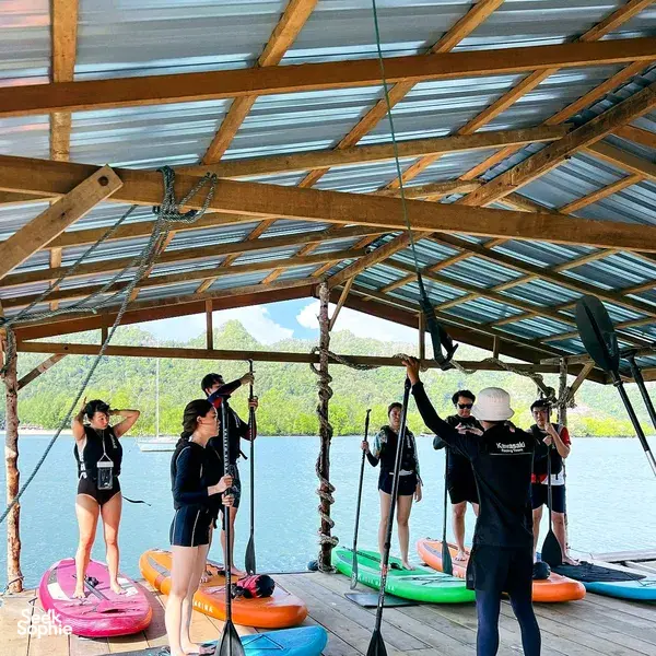 Boathouse briefing with stand-up paddleboards under a metal roof in Langkawi before heading to Tanjung Rhu