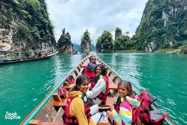 A group on a boat along limestone cliffs on Cheow Lan Lake during the 3D2N stay with Khao Sok Riverside Cottages