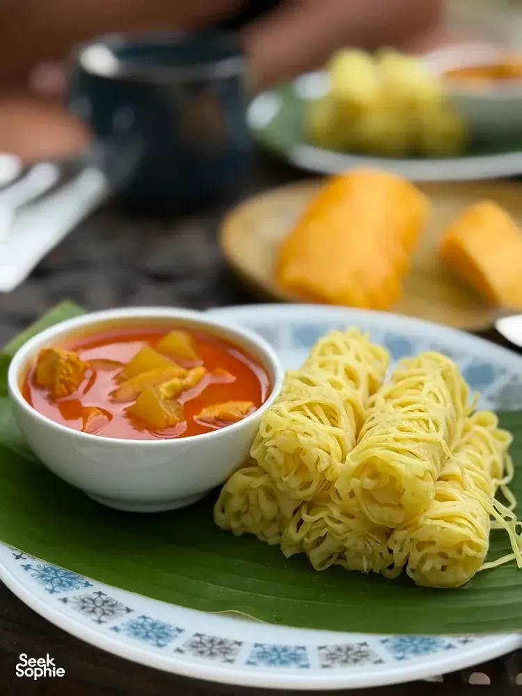 Malaysian comfort food of noodles and curry soup served on a banana leaf at Kebun Lidstari farmhouse kitchen in Langkawi