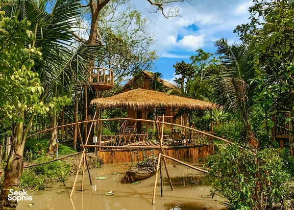 Bamboo Eco Village eco-homestay in Cần Thơ, Mekong Delta: thatched bamboo pavilion on stilts over a garden canal
