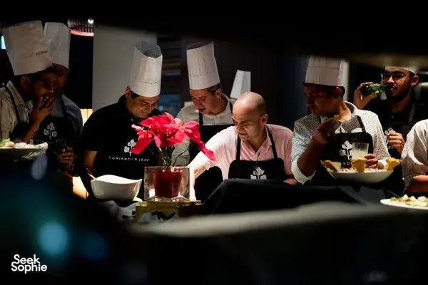 Chefs plate ingredients in Singapore during the team local produce cooking challenge, saucepans and bowls ready — workshops in Singapore