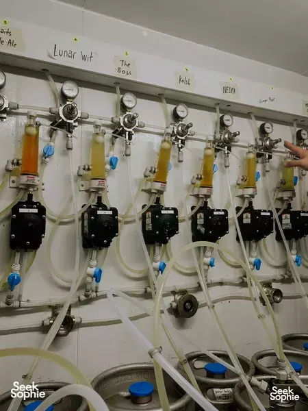 Close view of brewery dispensing equipment—valves and connected hoses—at Lion Brewery Co in Singapore for the brewpub tour