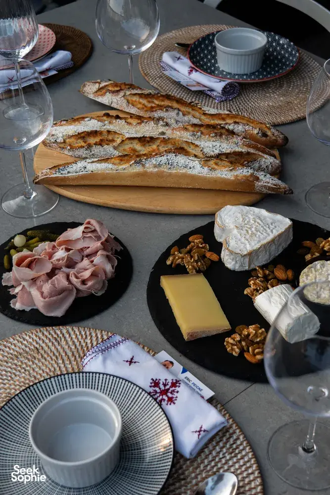 Sliced French baguettes on a wooden board with cheese, ham and nuts on a Singapore loft table for private dining Singapore