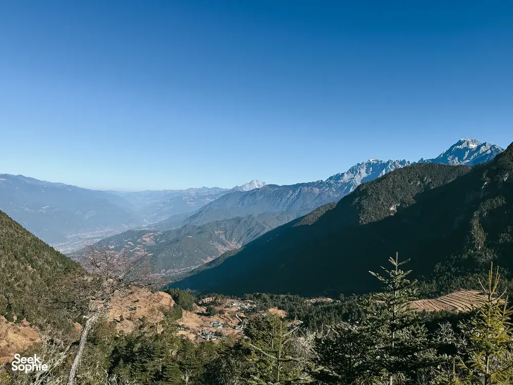 Viewpoint panorama of snow-capped peaks and deep mountain valleys across the landscapes of Jade Dragon Snow Mountain near Lijiang