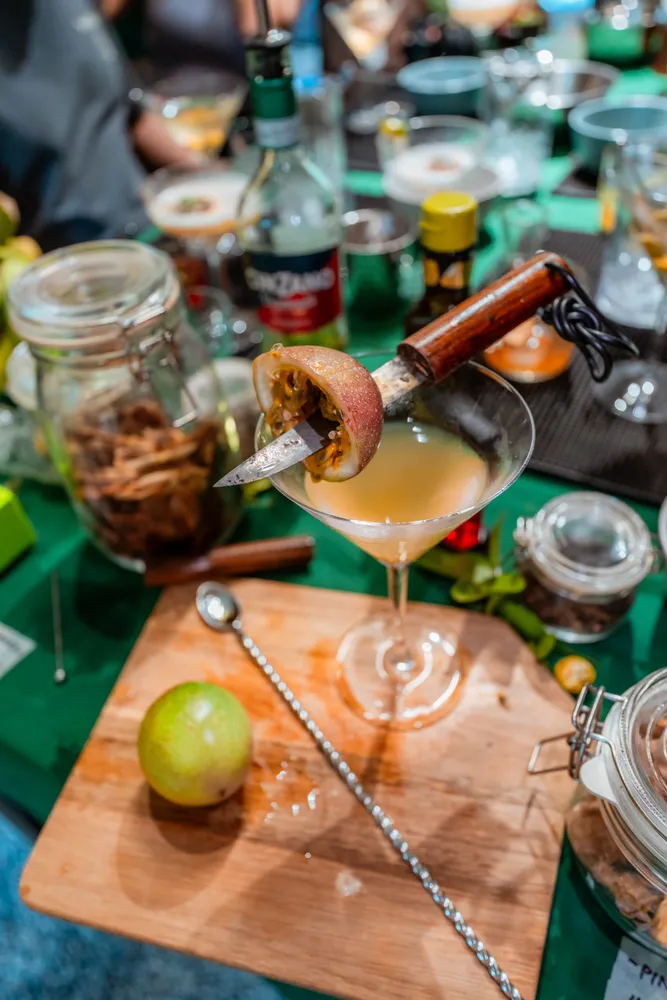 Drink being poured into a glass at a Singapore dining table with jars of ingredients and plates in the background — private dining Singapore