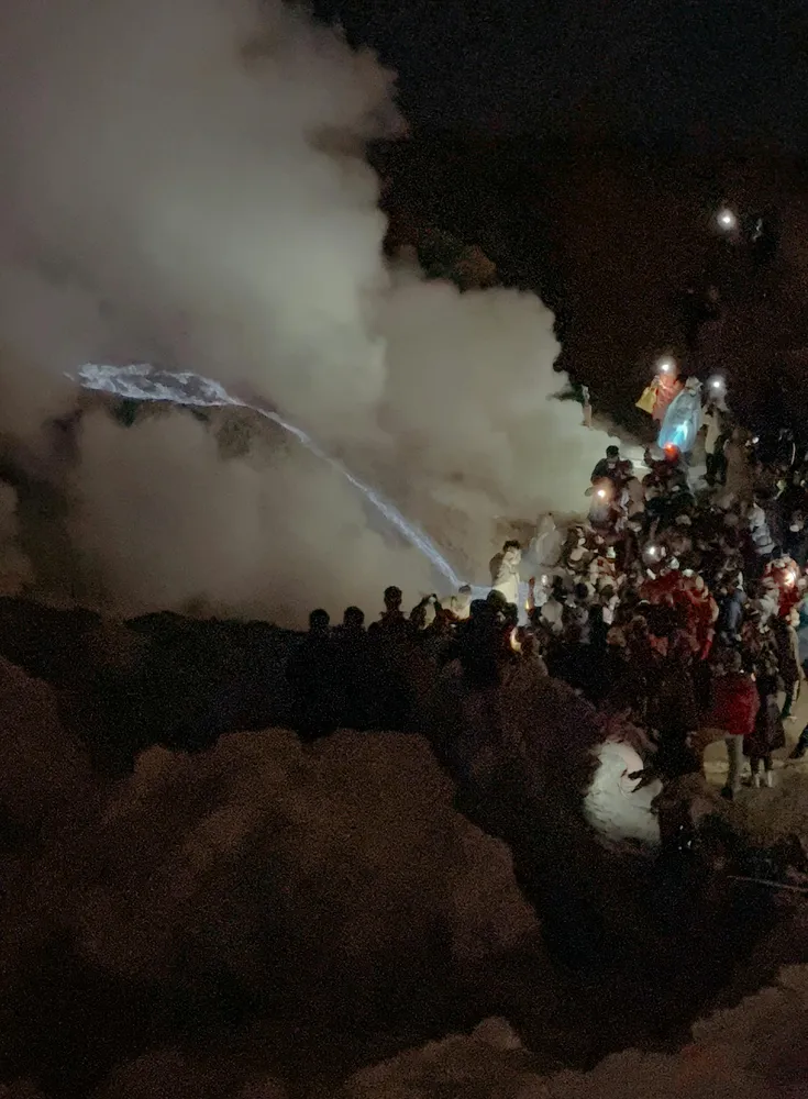 Crowd surrounding the flames 