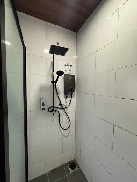 Rainfall shower and wall-mounted controls in the en-suite bathroom at Sukau Greenview Lodge, Sandakan, Kinabatangan River