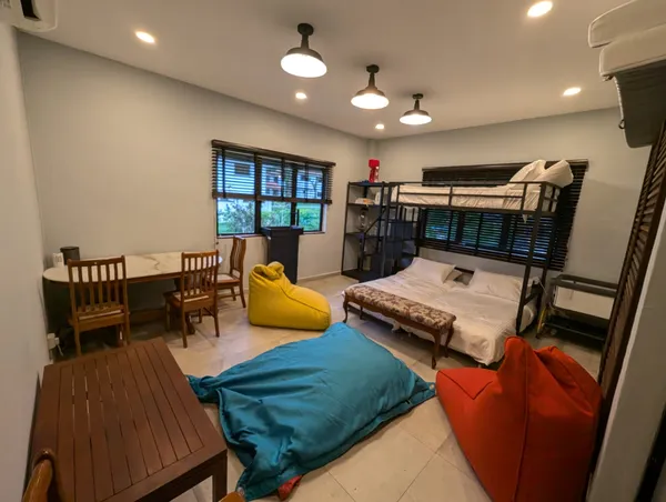 Farmstay bedroom in Singapore with a bunk bed, lounge chairs and a sofa bed for a 2D1N stay by The Unexpected — Singapore hidden gems