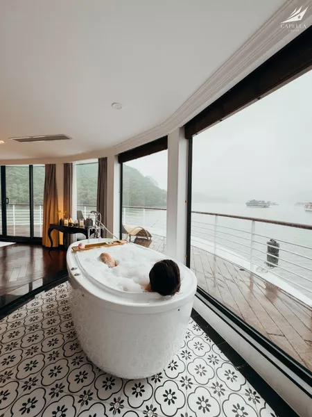Soaking tub on the deck-front balcony of a Halong Bay suite on a Lyra Cruise Collection 4D3N luxury cruise, with calm sea views