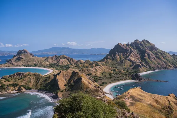 Aerial view of rugged coastlines, sheltered lagoons and sandy beaches from above, showing Komodo cruise scenery near Labuan Bajo