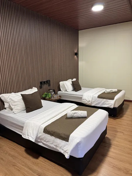 Twin beds in Sukau Greenview Lodge room for a 2D1N safari stay in Sandakan, Malaysia along the Kinabatangan River