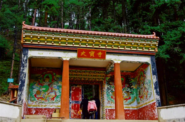 Tibetan prayer pavilion with colourful painted panels at the trail entrance near Shangri-La, hosted by Mission Liotard