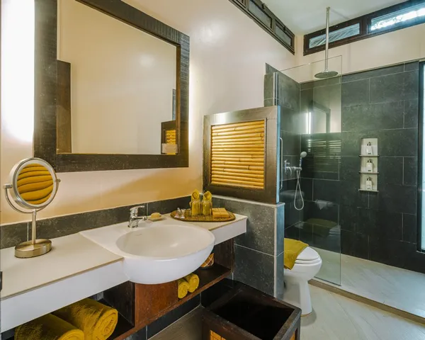 Bathroom at Borneo Rainforest Lodge in Danum Valley, with twin wash basins, walk-in shower, and modern toilet suite