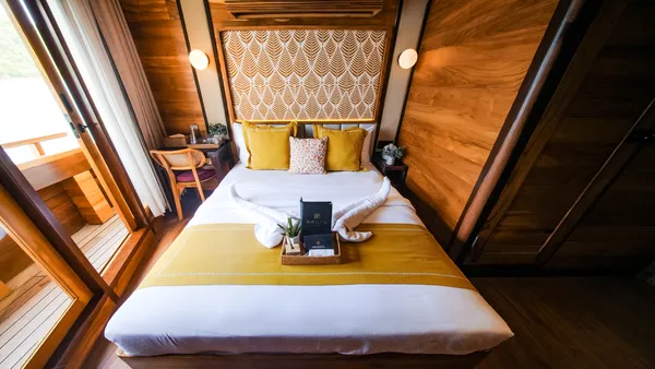 Angelica Liveaboard suite on a 3D2N luxe Komodo cruise with a neatly folded blanket and welcome amenities in Labuan Bajo